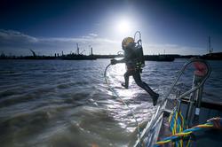 A PLA diver enters the Thames